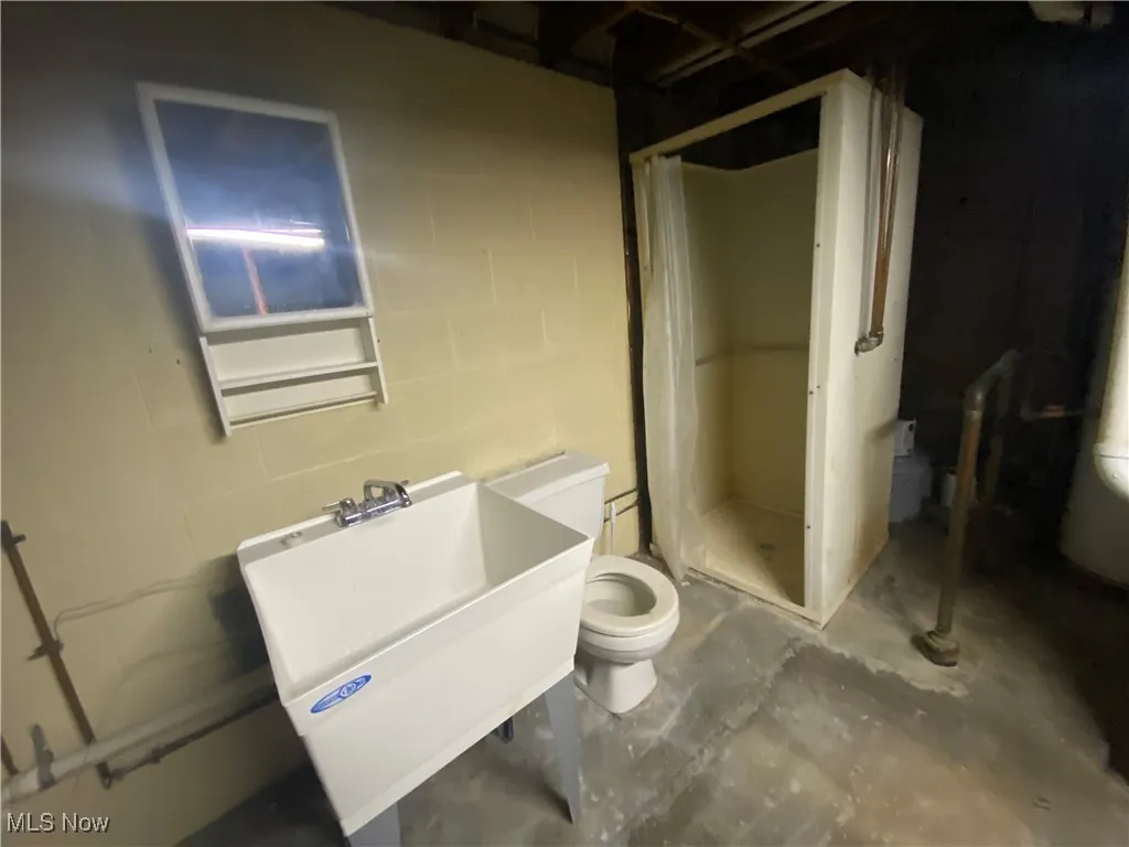 Basement bath plumbing with sink, toilet and shower stall