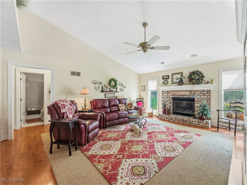 Great Room with Vaulted Ceilings, Custom Built-ins, Stunning Real Hardwood Floors, and  Brick Fireplace (Gas)