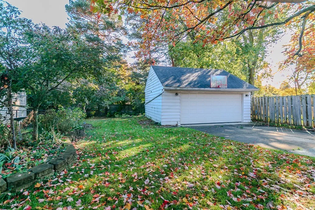 Detached garage with view of wooded area