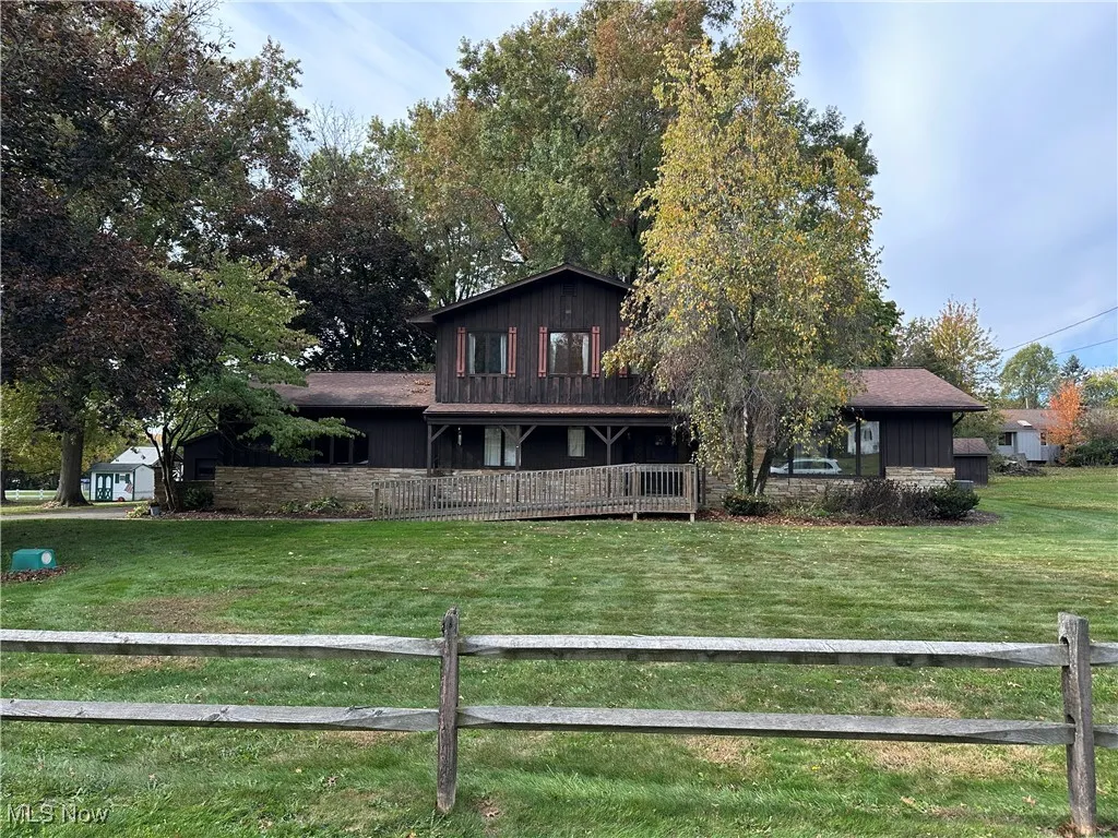 View of front facade with covered porch and board and batten siding