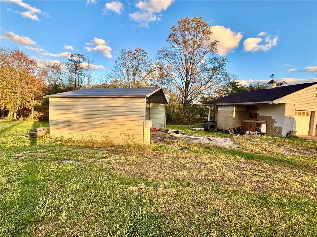 View of green lawn with an outbuilding