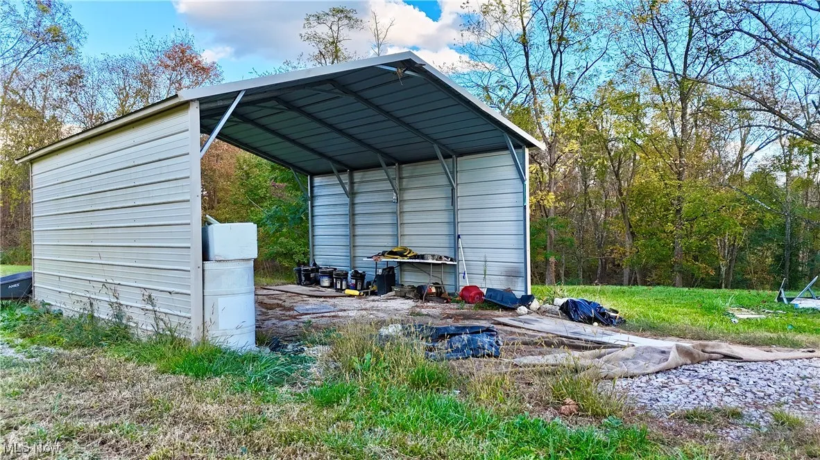 View of outbuilding featuring a detached carport