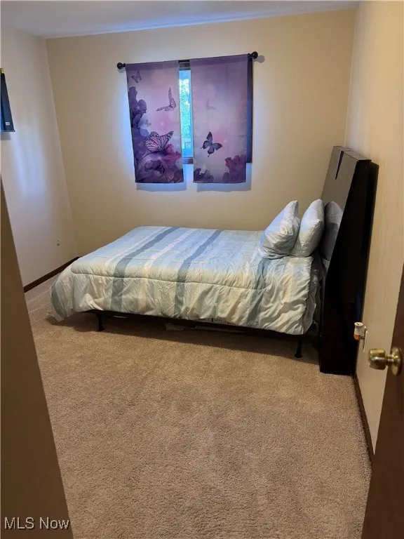 Bedroom with carpet and baseboards
