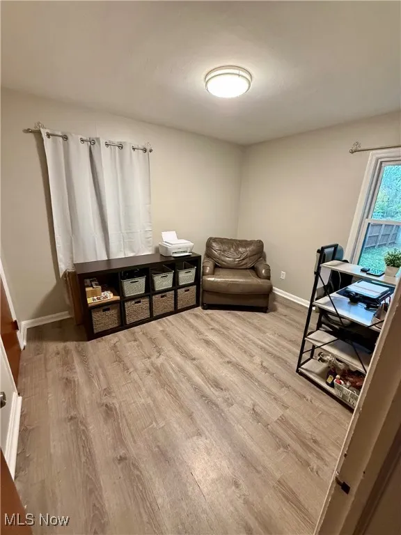 Sitting room featuring light wood finished floors and baseboards
