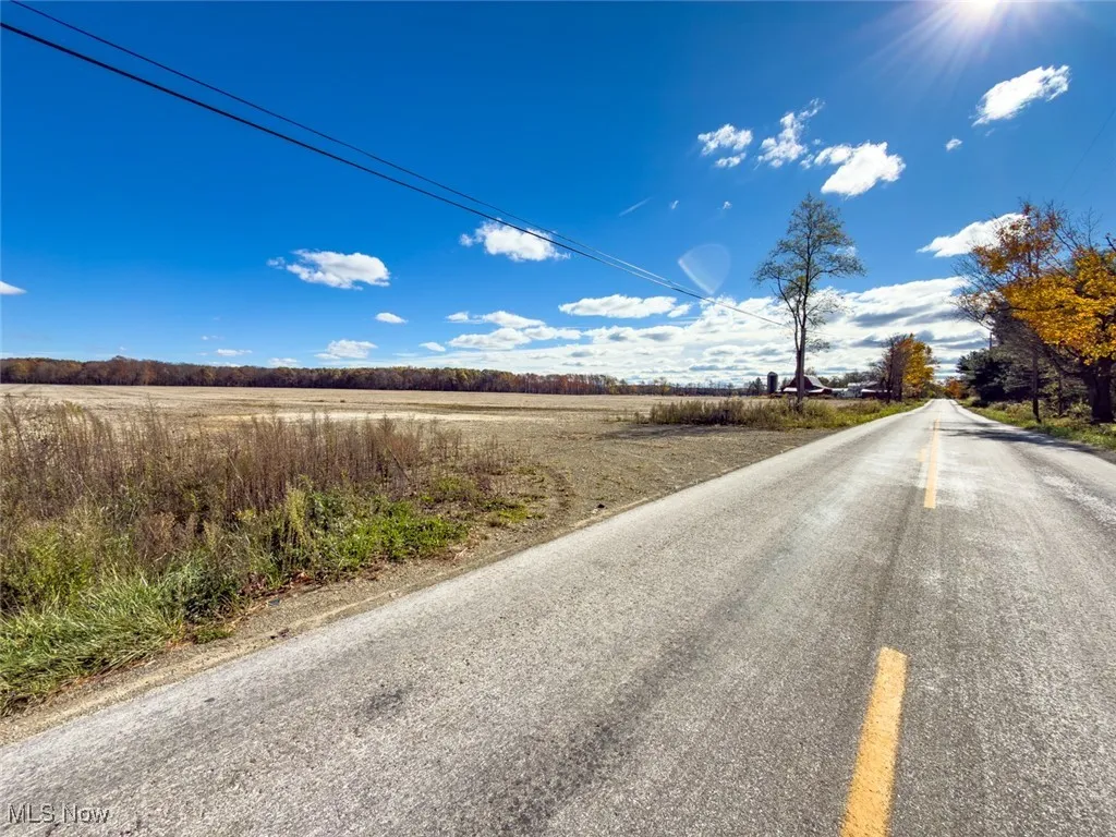 View of asphalt road with a view of countryside