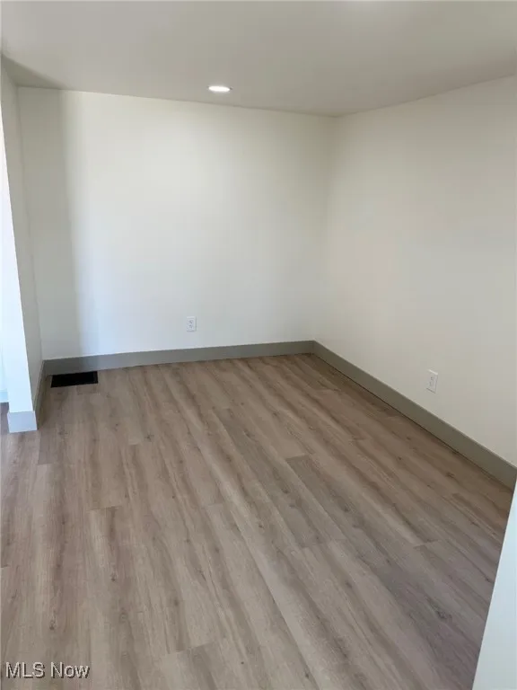 Unfurnished room with light wood-style floors and recessed lighting