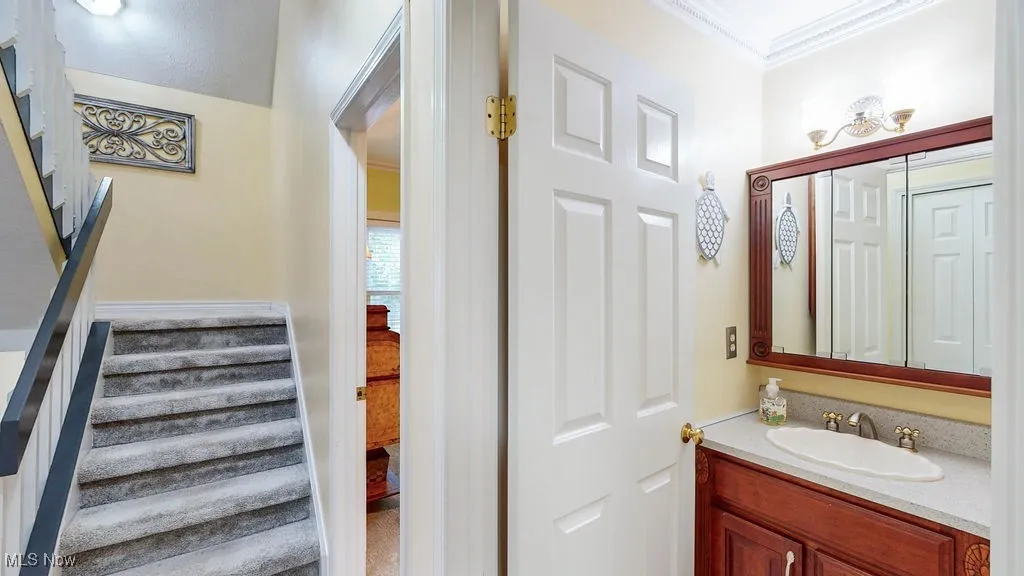 Bathroom with vanity and crown molding