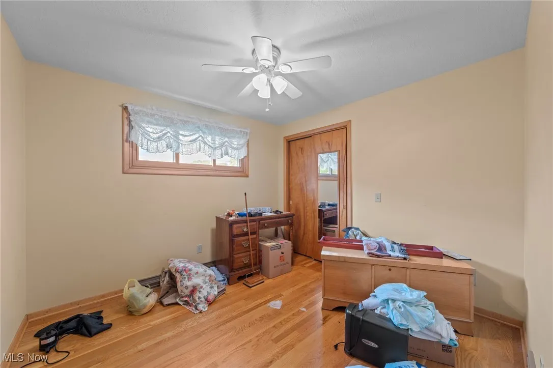 Home office featuring wood finished floors and ceiling fan