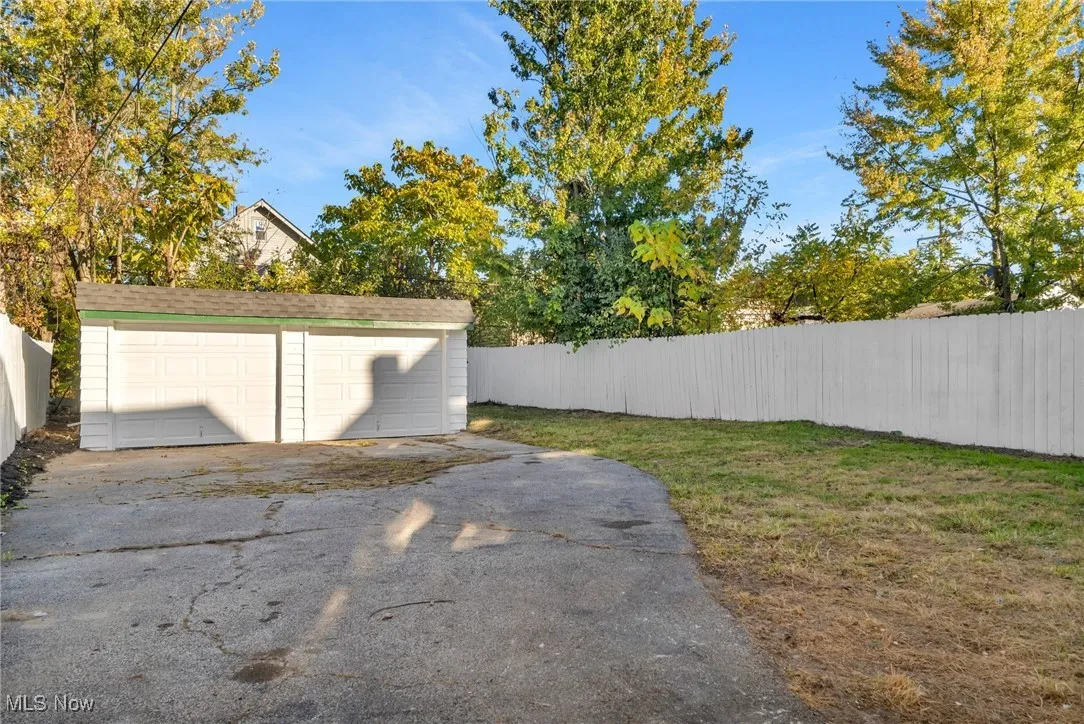 View of yard with an outbuilding and a garage