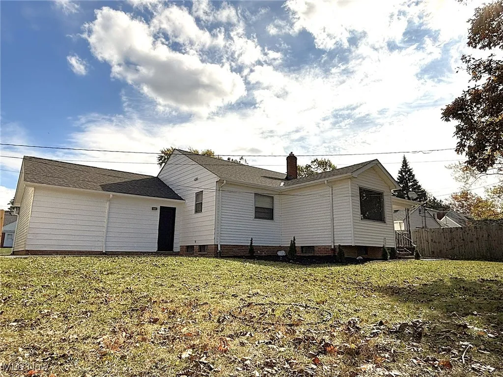 Rear view of house with a chimney and crawl space