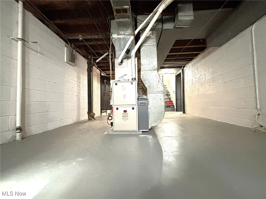 Unfinished basement featuring heating unit