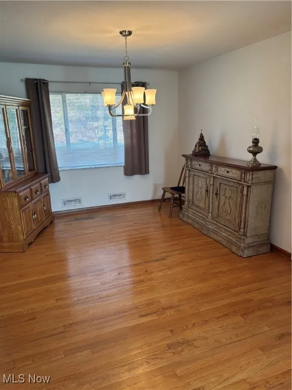 Dining space featuring a chandelier and light wood finished floors