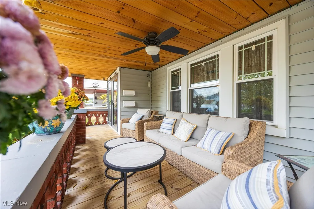Wooden terrace featuring outdoor lounge area and a ceiling fan