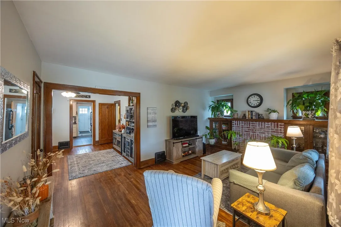 Living room with hardwood / wood-style flooring and healthy amount of natural light