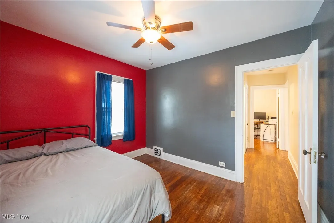 Bedroom with dark wood-type flooring and ceiling fan