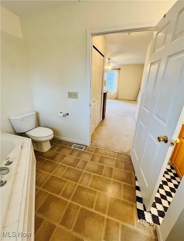 Bathroom with a relaxing tiled tub and light tile patterned floors