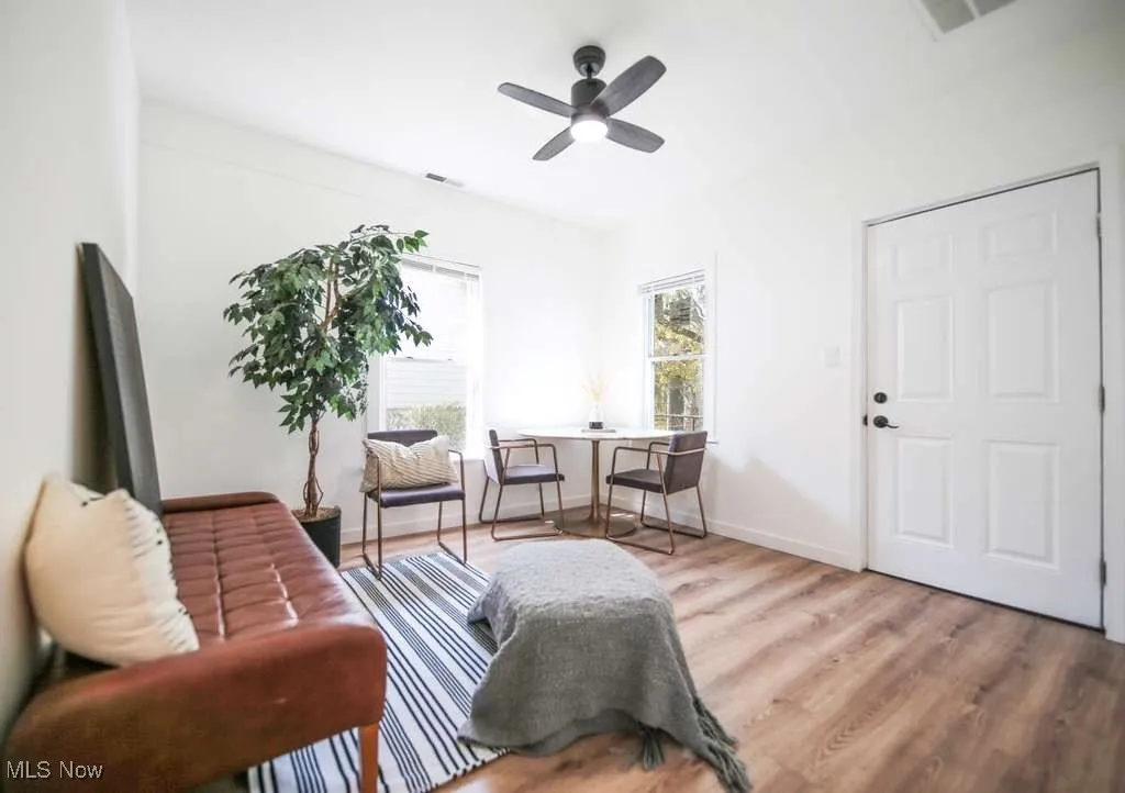 Living area featuring light wood-style floors and ceiling fan