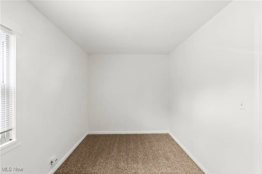 Bedroom with Neutrally Painted Walls & Fresh Carpeting