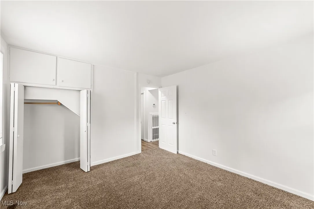 Bedroom with Neutrally Painted Walls & Fresh Carpeting