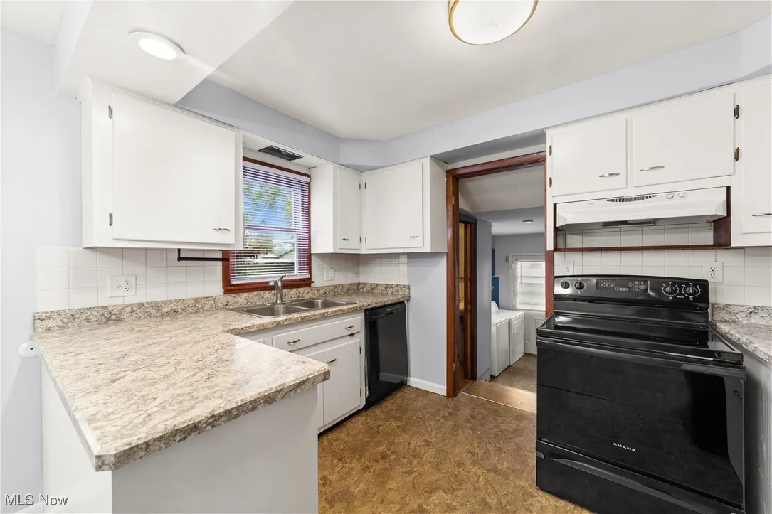 Kitchen area with White Cabinets and Neutrally Painted
