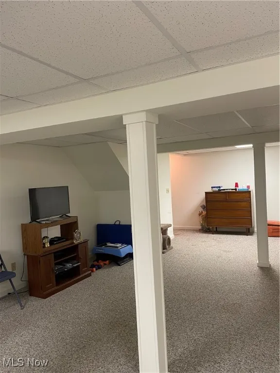 Finished below grade area with a drop ceiling and carpet