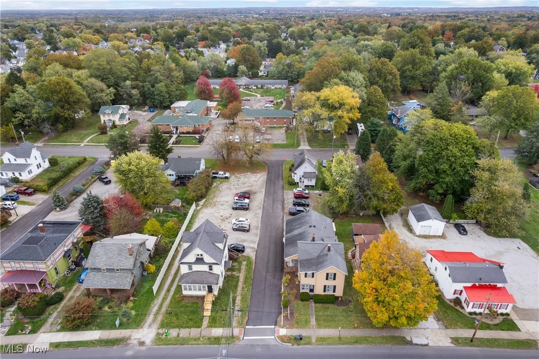 Aerial view of property and surrounding area with nearby suburban area