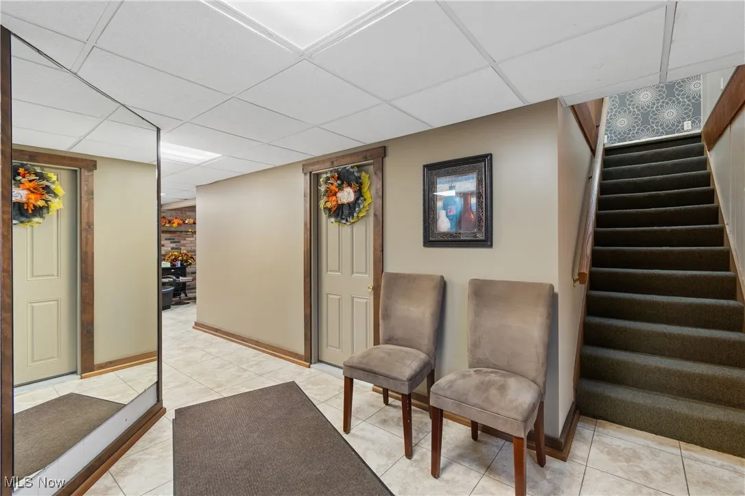 Lobby with a drop ceiling and stairs