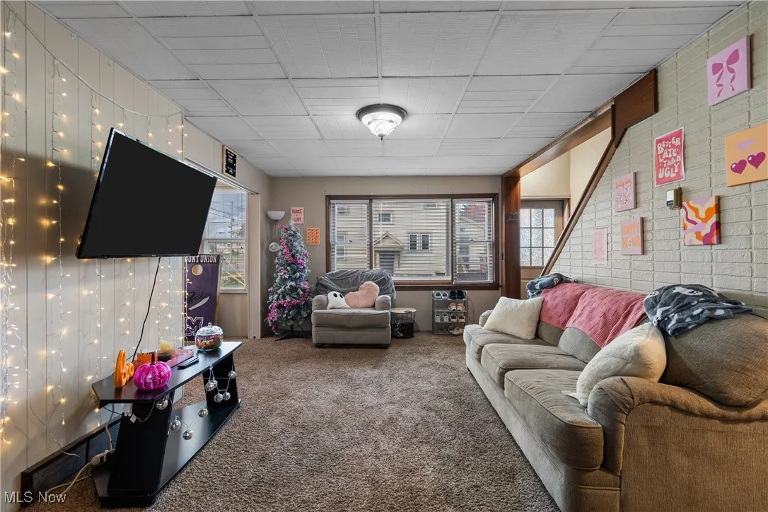 Living area featuring plenty of natural light and carpet flooring