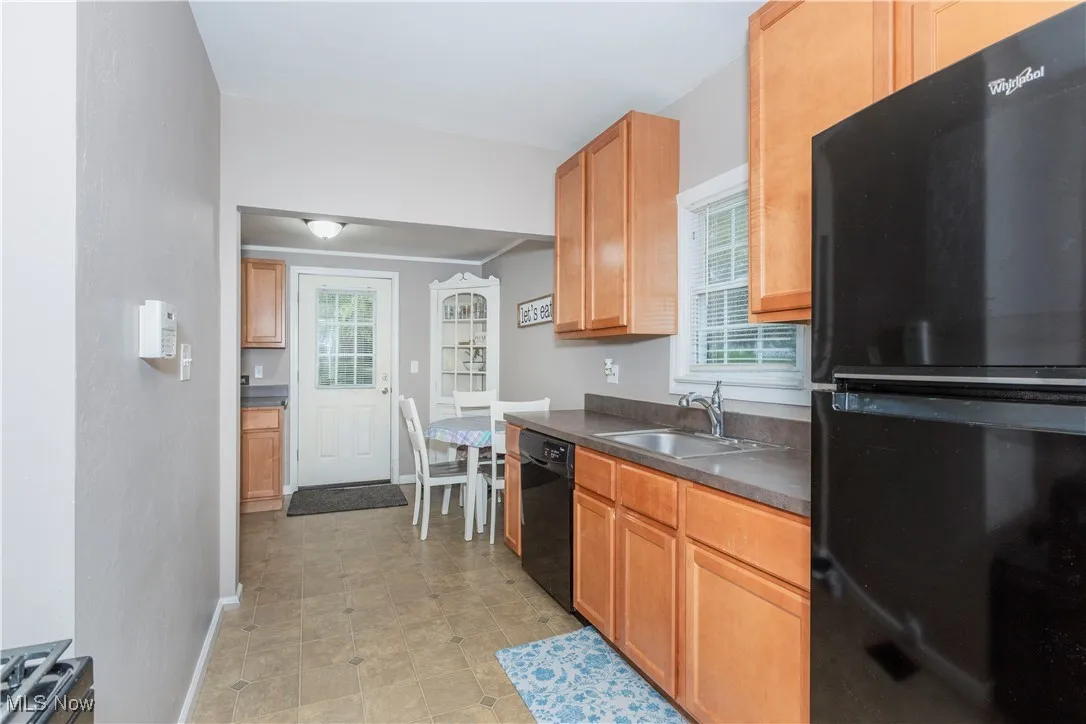 Kitchen with black appliances and dark countertops