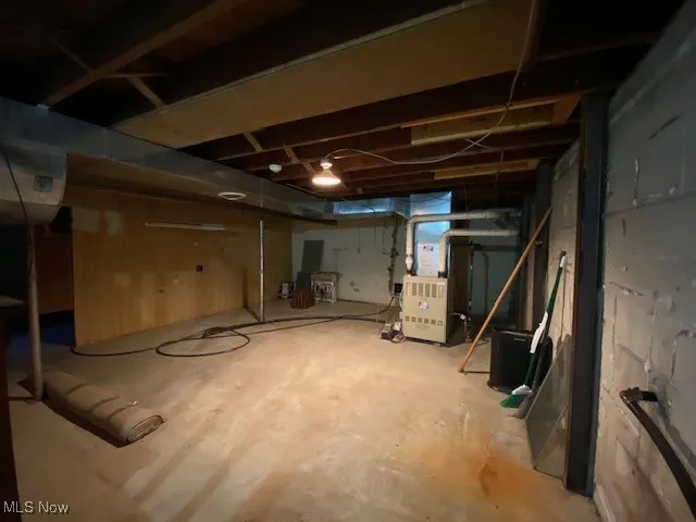 Unfinished basement featuring heating unit