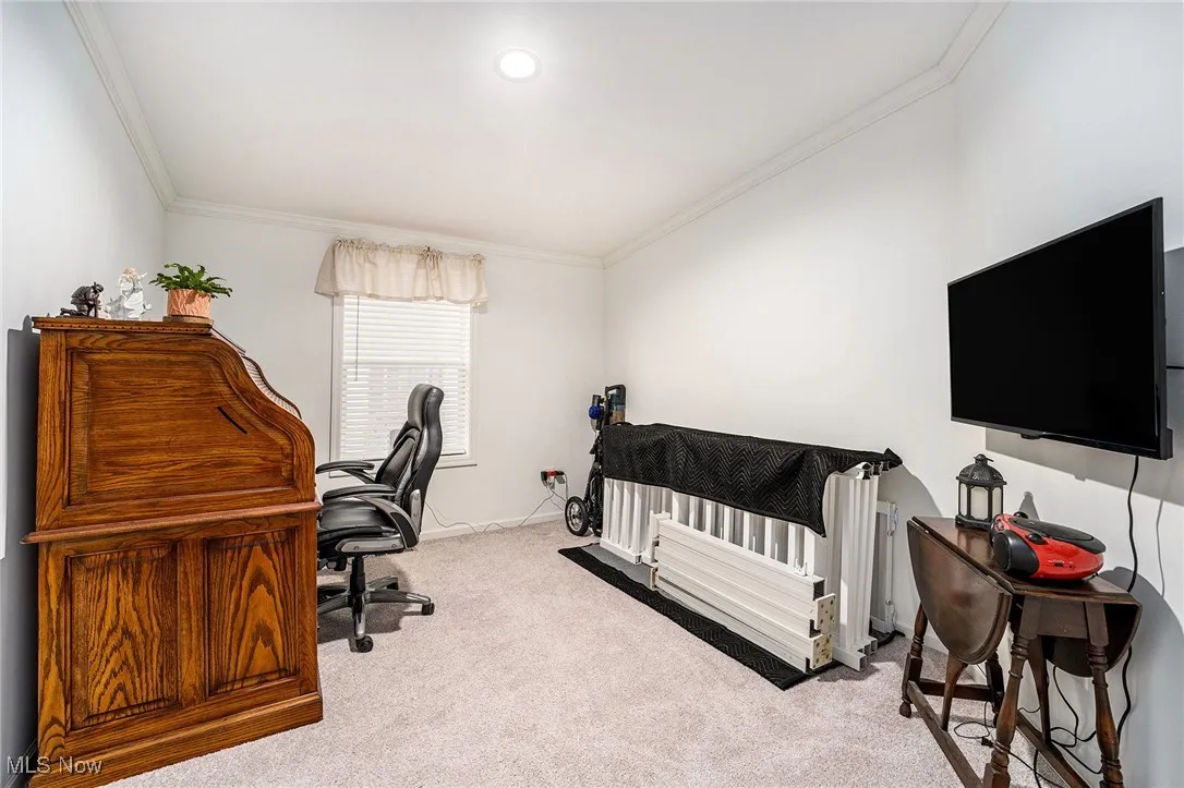 Office featuring ornamental molding and light carpet