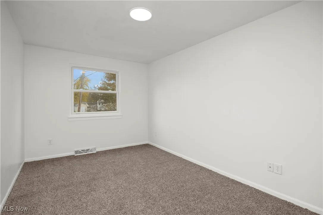 Spare room with carpet flooring and baseboards