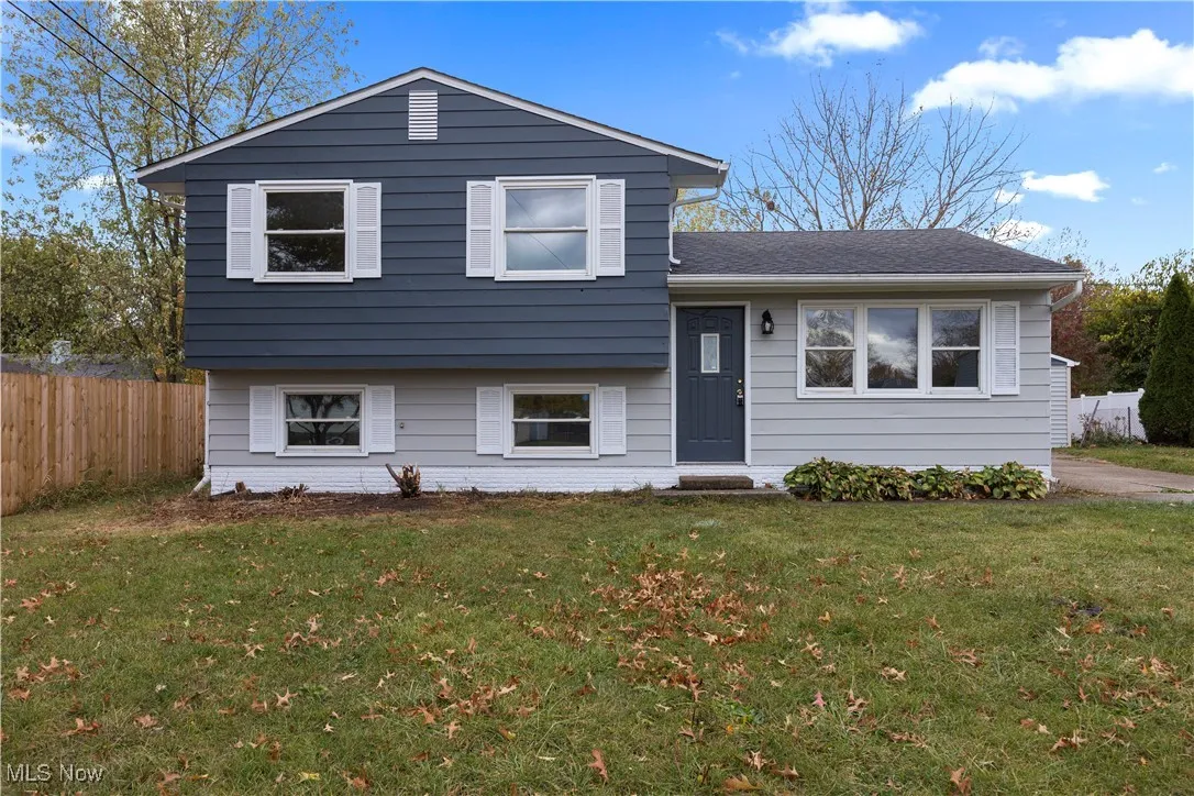 Tri-level home featuring roof with shingles