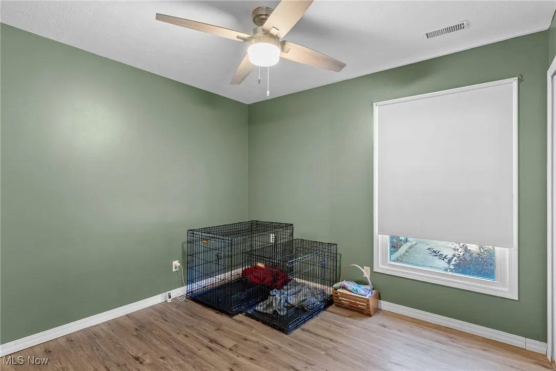 Spare room featuring wood finished floors and baseboards