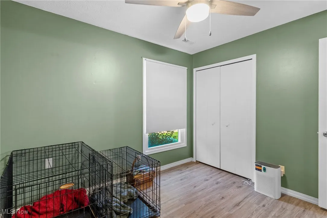 Home office featuring wood finished floors and a ceiling fan