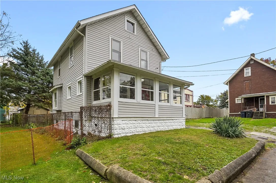 View of property exterior with a sunroom