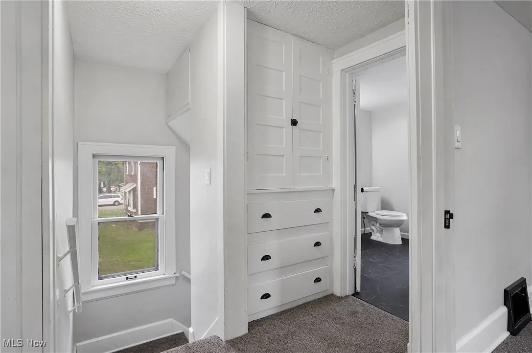 Bathroom with vanity, dark marble finish floors, and a freestanding bath