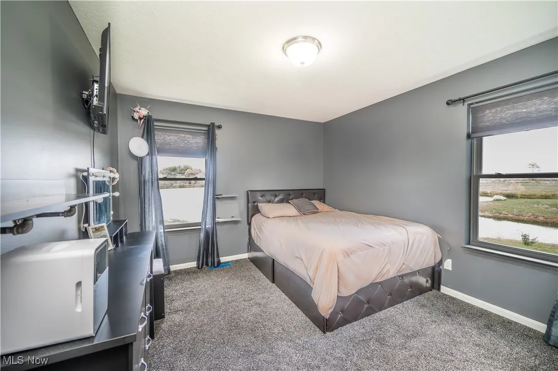 Carpeted bedroom with baseboards