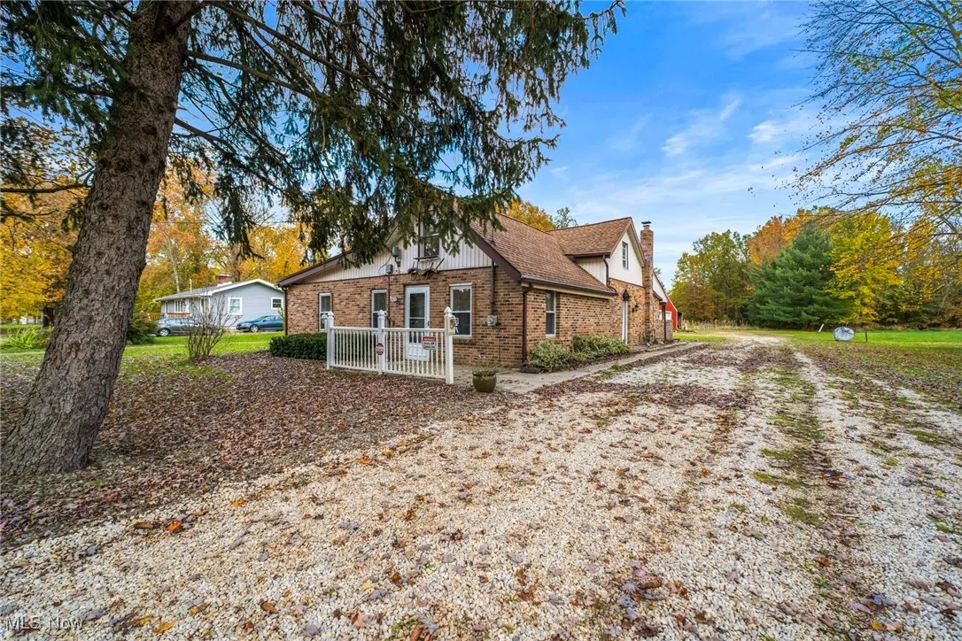 View of home's exterior with brick siding and a chimney