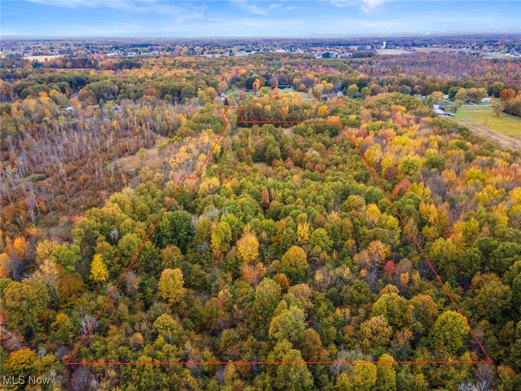 Aerial view of property and surrounding area featuring property boundaries highlighted