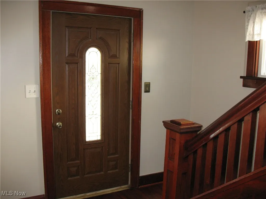 Foyer entrance featuring stairway and dark wood finished floors