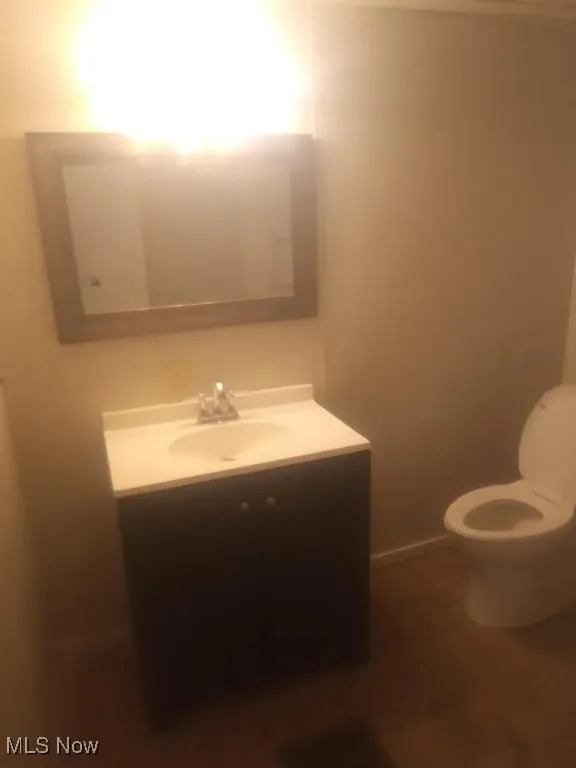 Half bath featuring vanity and toilet
