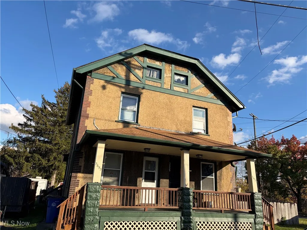View of front of property with covered porch and brick siding