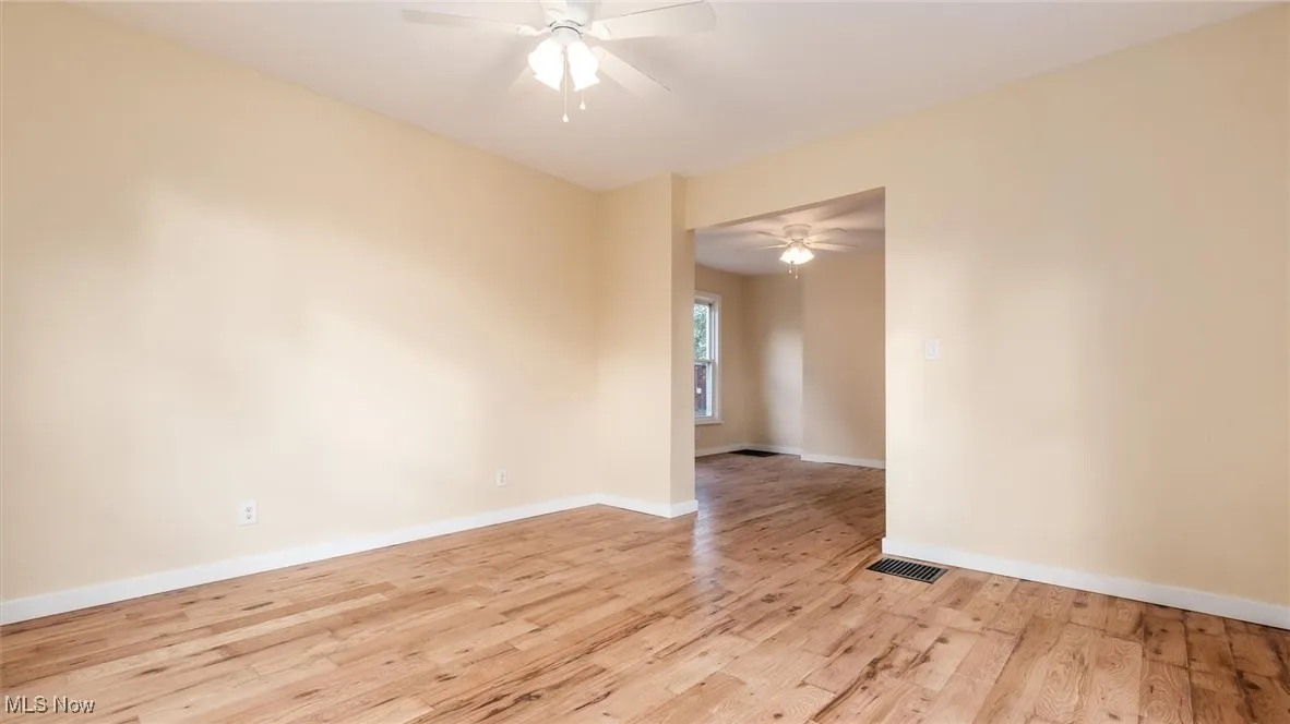 Unfurnished room featuring light wood-type flooring and a ceiling fan