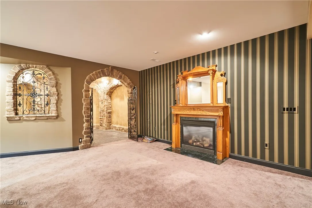 A carpeted rec room is in the lower level with a gas fireplace