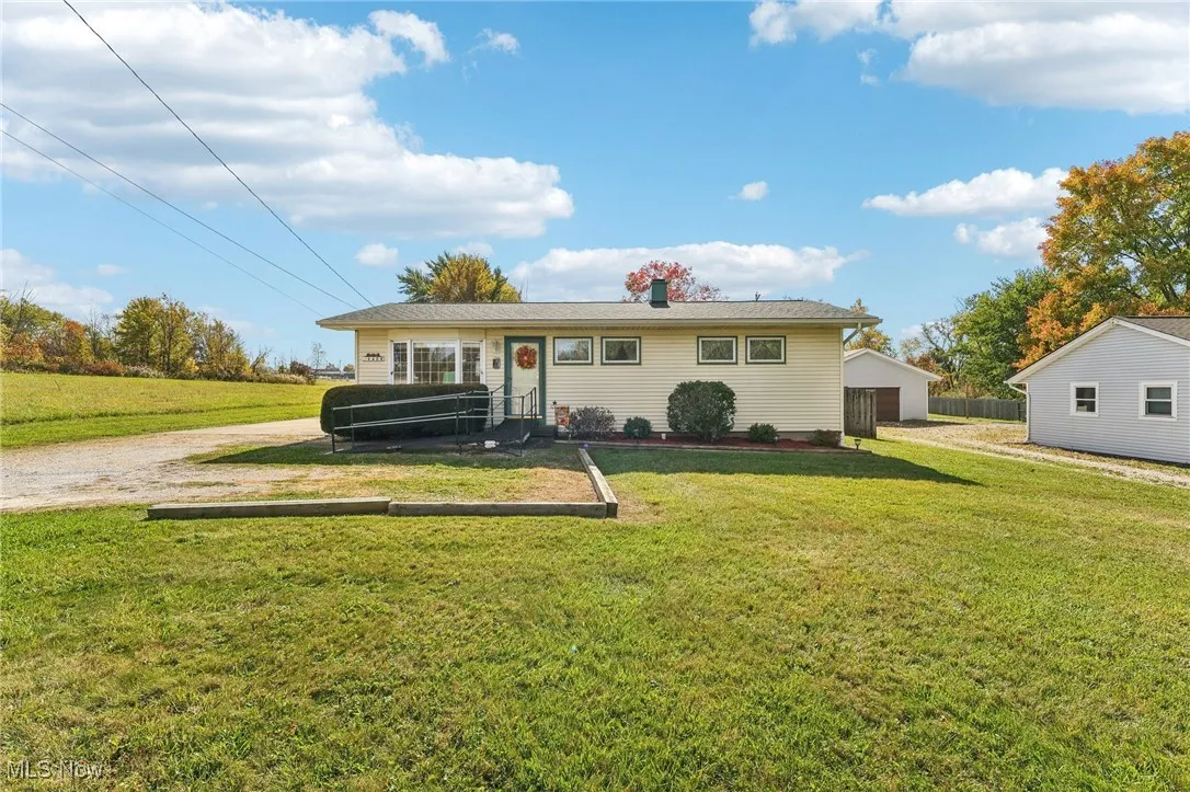 View of front of home featuring a front yard and a chimney