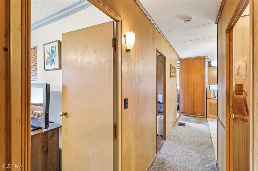 Hallway featuring carpet flooring