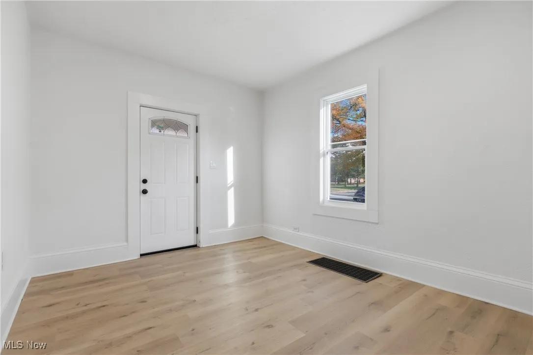 Entrance foyer featuring light wood-style floors