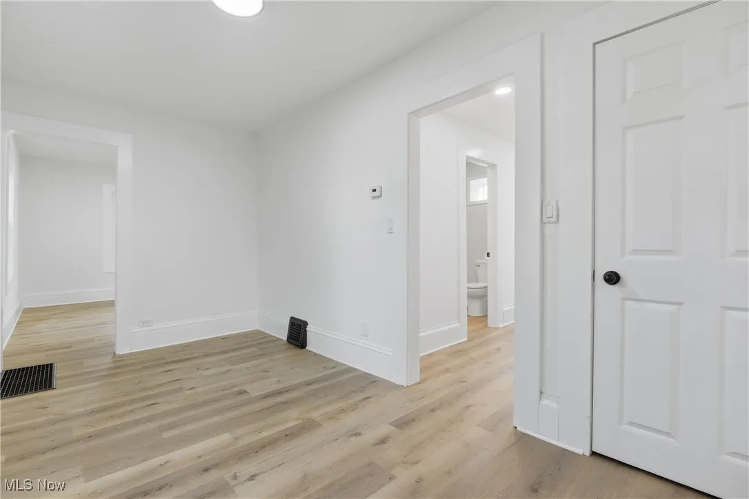 Empty room with light wood-style flooring and baseboards