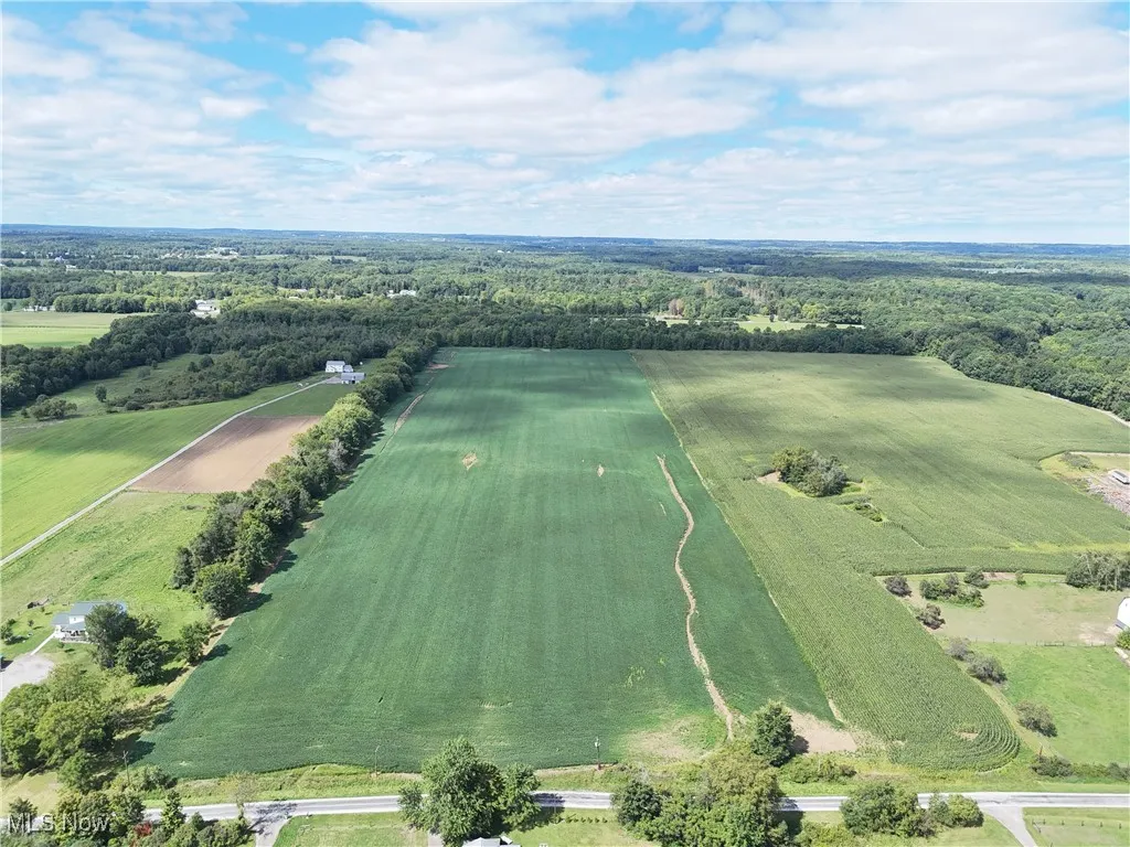 Aerial overview of property's location with a forest and rural landscape